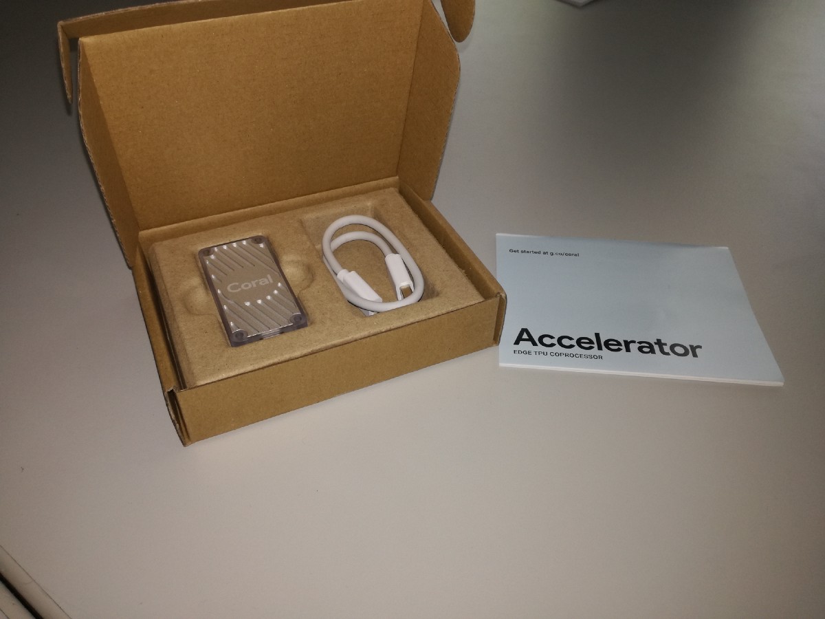 Box containing the USB Accelerator, USB Type-C to USB 3 Adapter and a simple getting started instruction